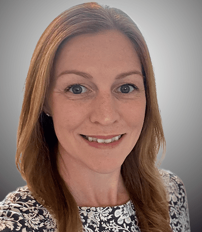 A woman with long hair and blue eyes.